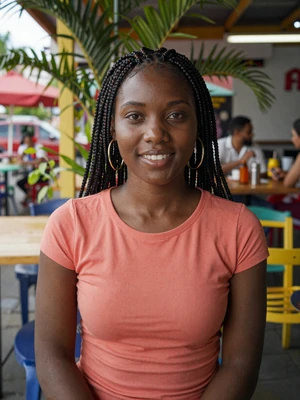 Shanice, 26, Jamaican woman from Kingston with box braids at a colorful Caribbean cafe - Latin 312 Dating verified profile
