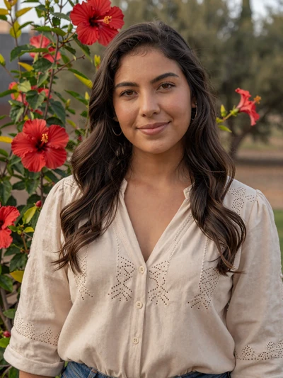 Perla, 27, Paraguayan woman from Villarrica in embroidered beige blouse at garden with hibiscus flowers - Latin 312 Dating profile