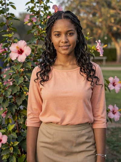 Anita, 26, mixed heritage Guyanese woman from Anna Regina in garden with hibiscus flowers - Latin 312 verified profile