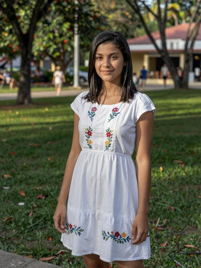 Rosalina, 24, Dominican single from Santiago in white floral dress at green park - verified dating profile
