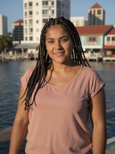 Monique, 26, Belizean Creole woman from Belize City with braided hair in rose top at the waterfront - Latin 312 verified profile