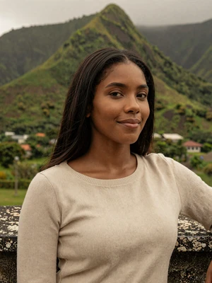Simone, 27, Vincentian woman from Layou with serene smile against green mountain backdrop - Latin 312 Dating verified profile